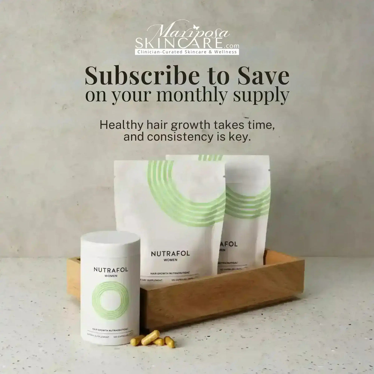 Nutrafol Women hair growth nutraceutical supplements in a wooden tray.