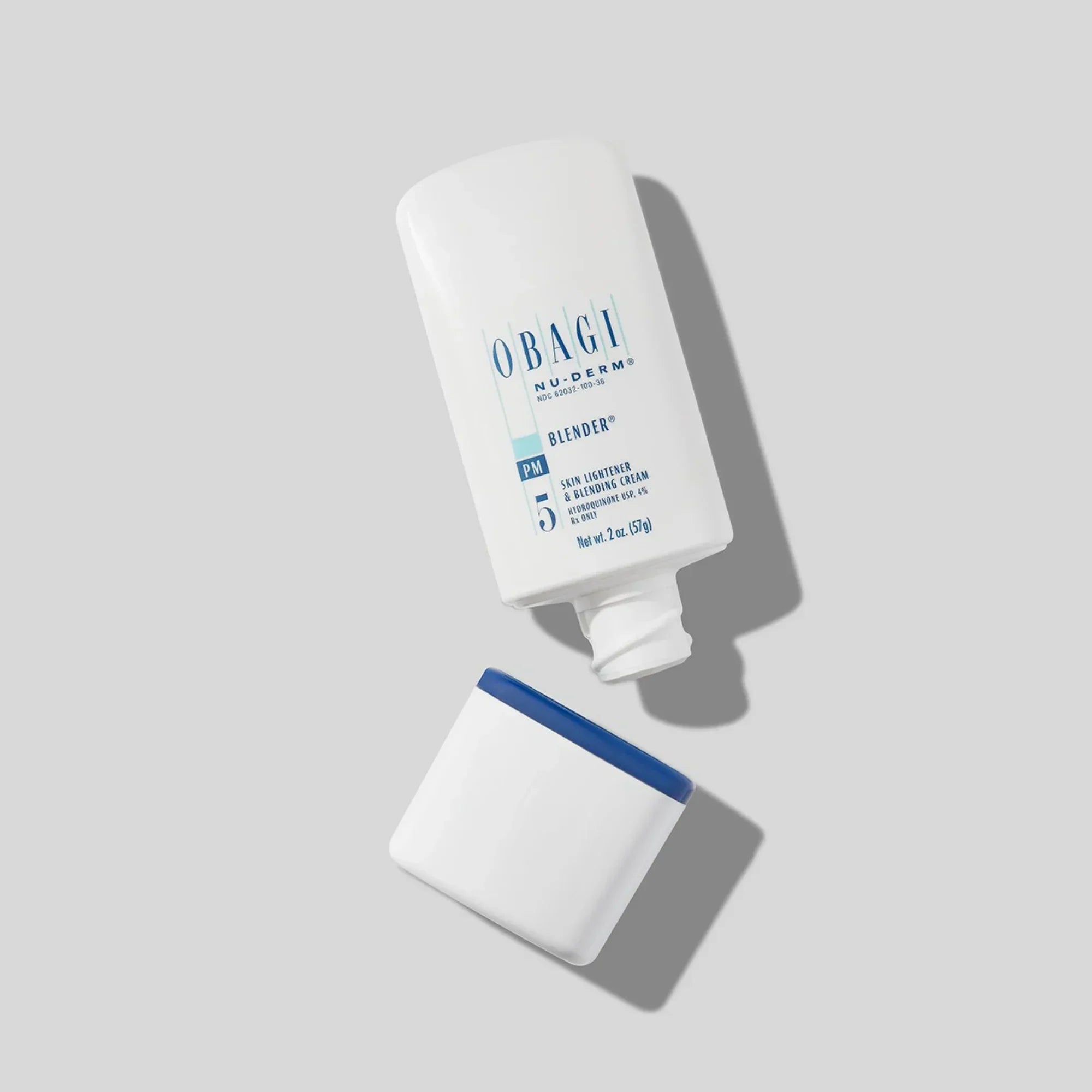 Obagi Nu-Derm Blender PM 5 skin cream bottle with blue and white cap on gray background