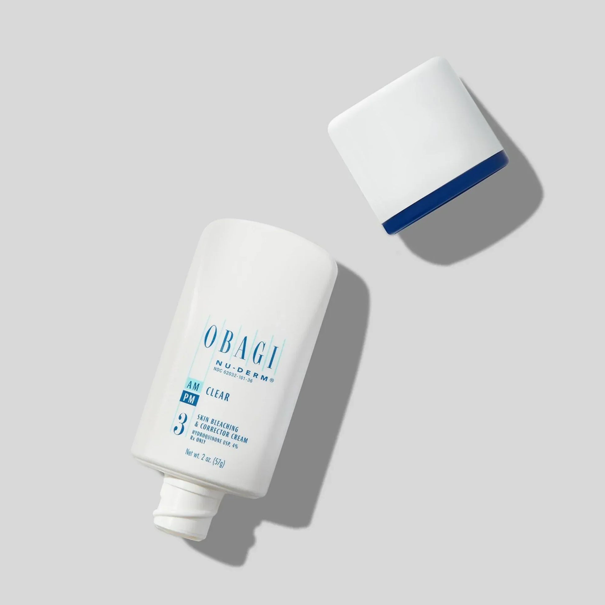 Obagi Nu-Derm Clear skin brightening cream bottle with detached cap on light background