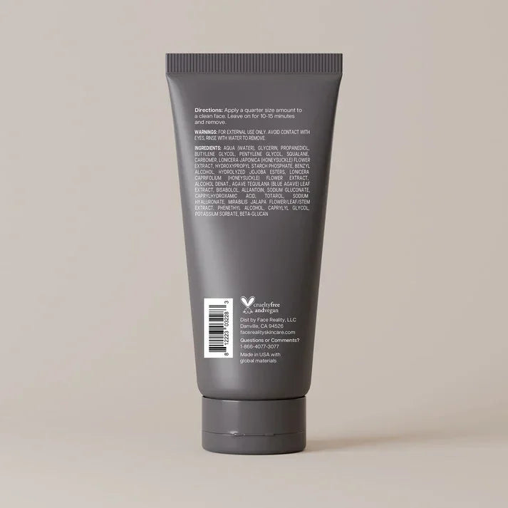 Back view of a gray skincare tube with ingredient list and cruelty-free label on a neutral background