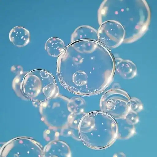 Clear ethereal bubbles floating on a light blue background, symbolizing freshness and purity