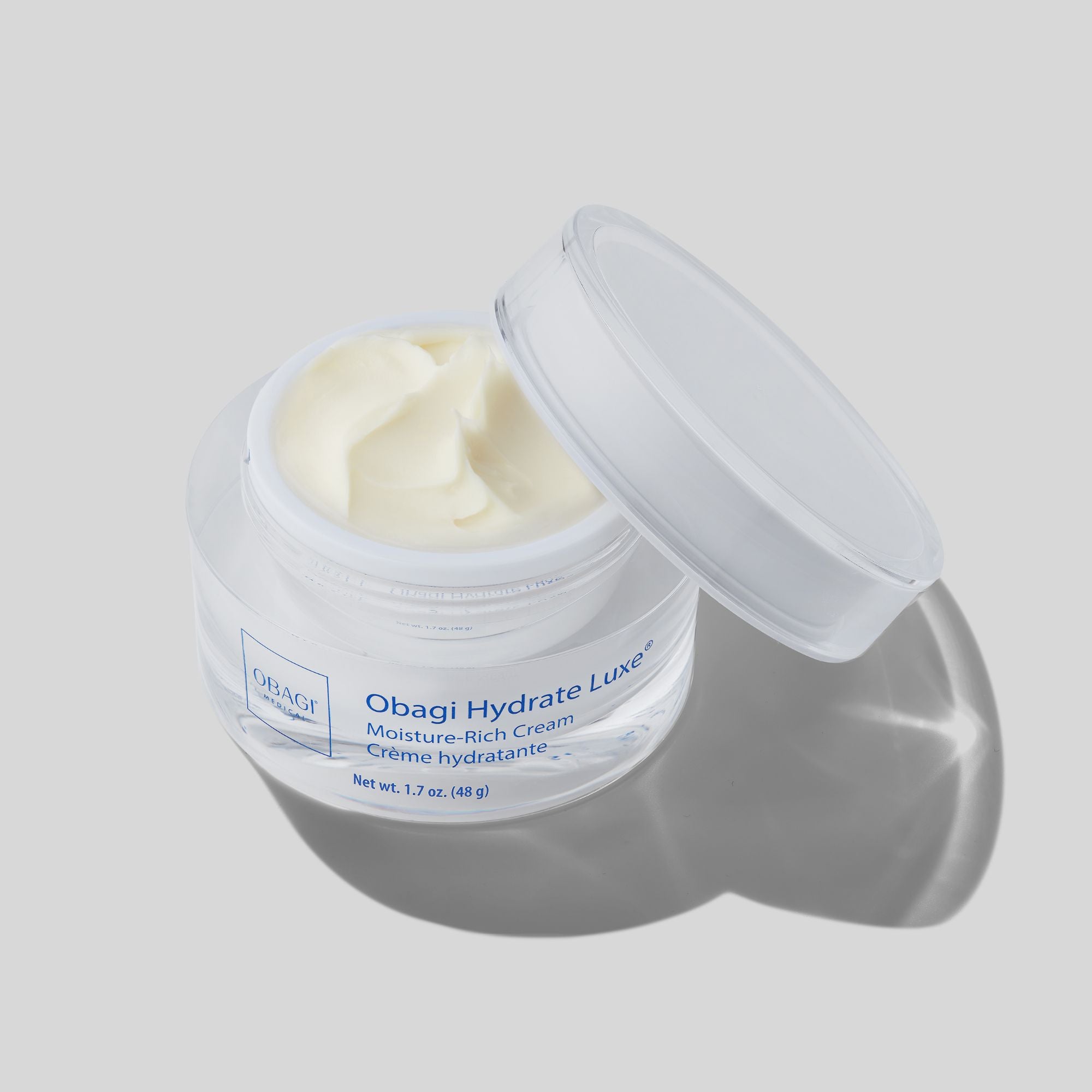 Obagi Hydrate Luxe Moisture-Rich Cream in clear jar with lid open, showcasing creamy texture for hydration