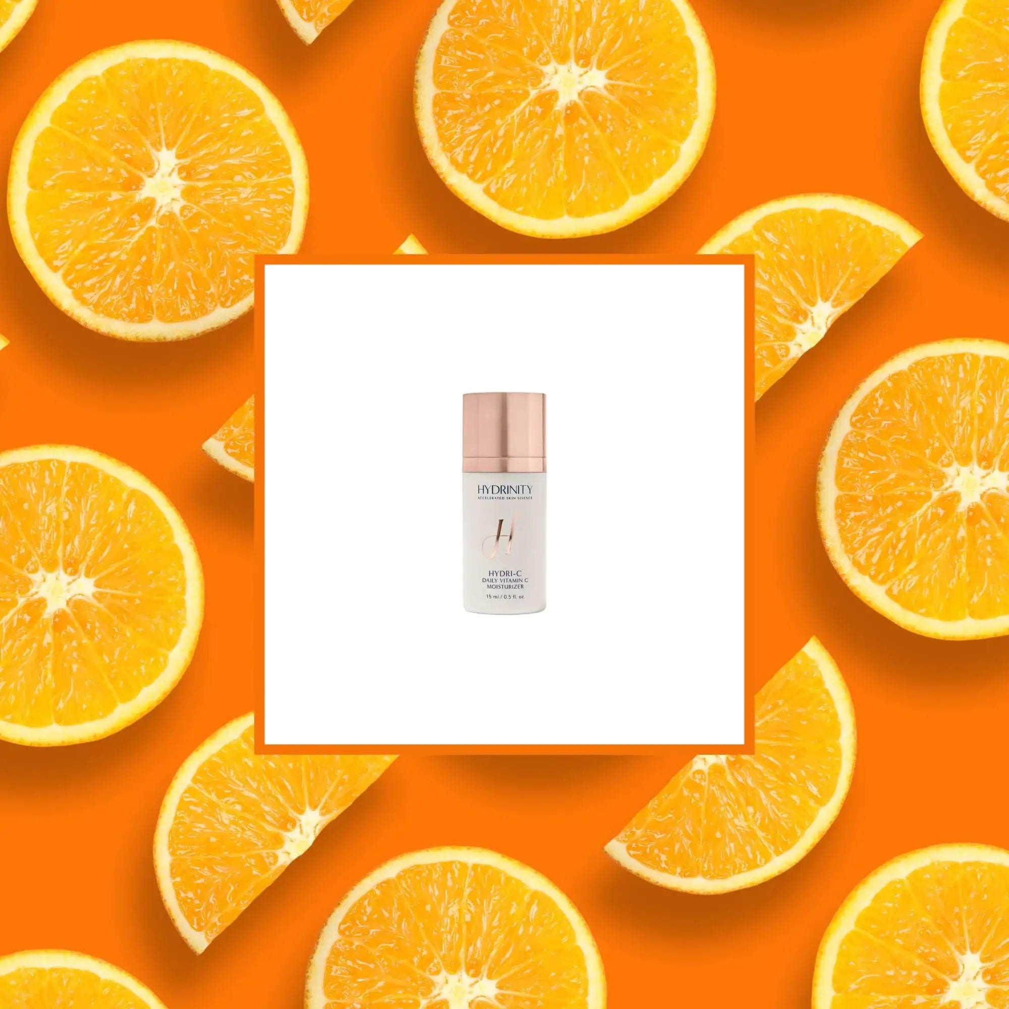 Hydrinity HYDRI-C vitamin C serum bottle on white background, surrounded by fresh orange slices