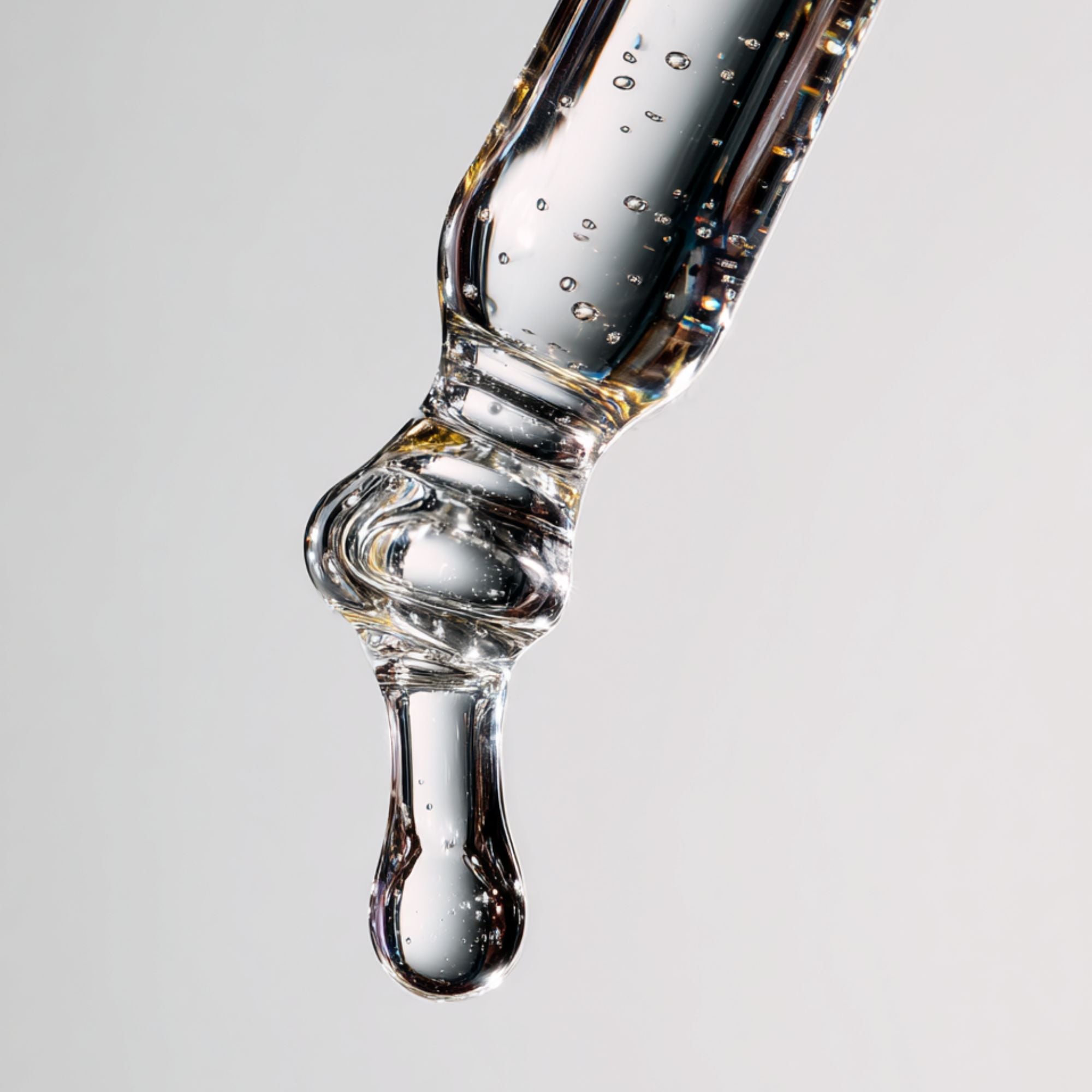 Clear skincare serum droplet from glass pipette, pure hydration for glowing skin