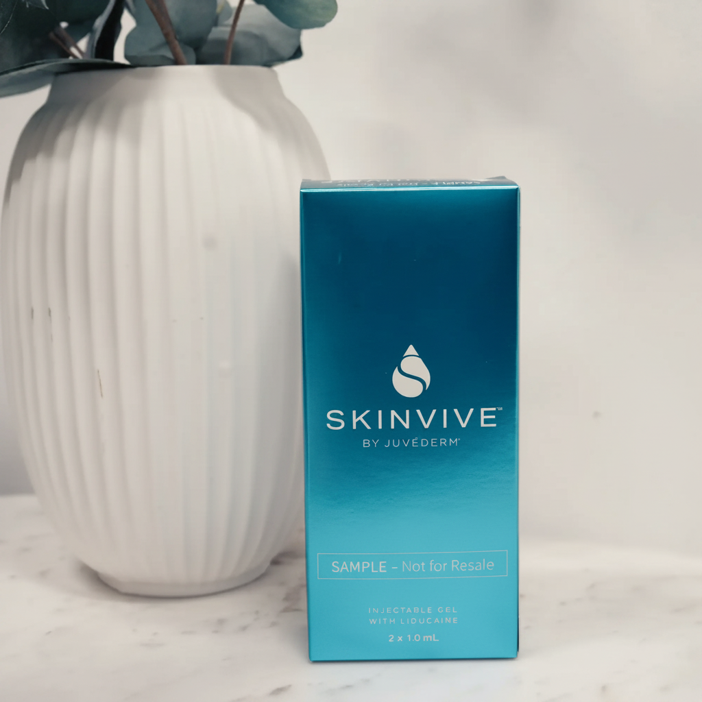 SKINVIVE by JUVÉDERM sample injectable gel box on marble surface beside white vase