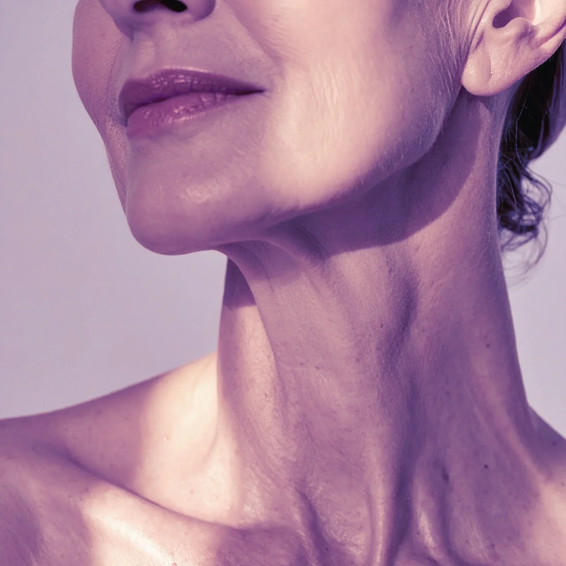 Close-up of mature woman's lower face and neck showing healthy, smooth skin