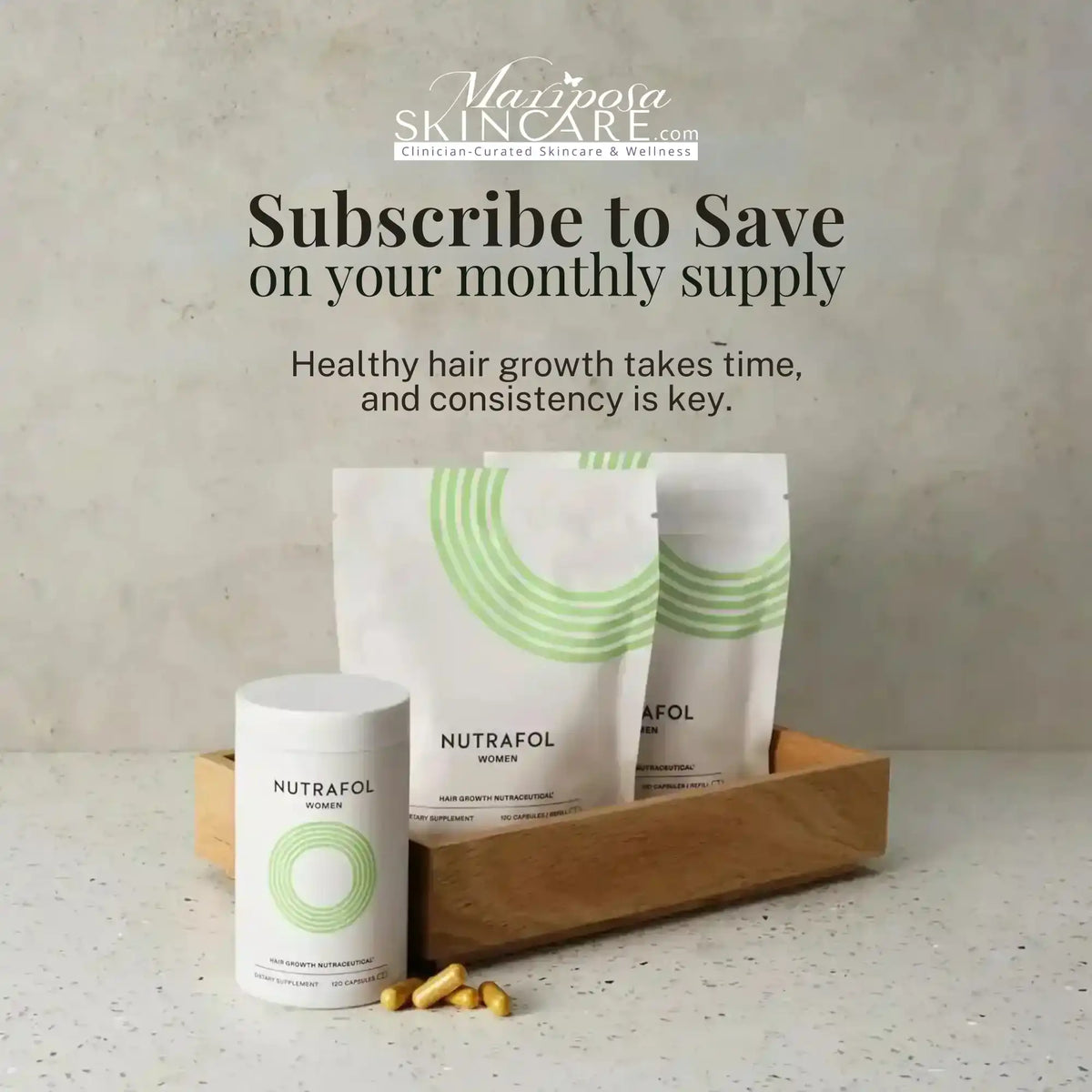 Nutrafol Women hair growth nutraceutical supplements in a wooden tray.