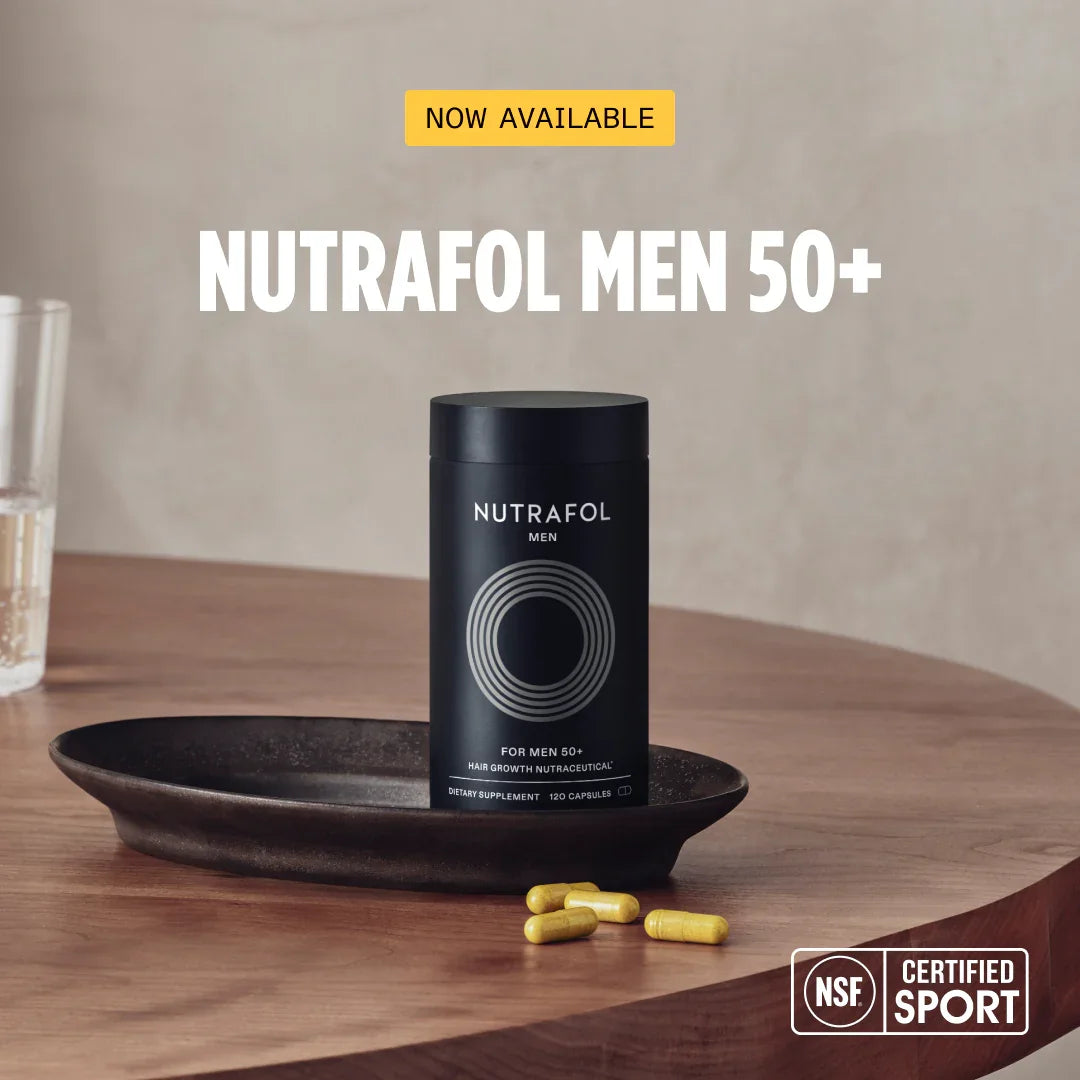 Nutrafol Men 50+ hair growth supplement bottle with capsules on wooden table, NSF certified