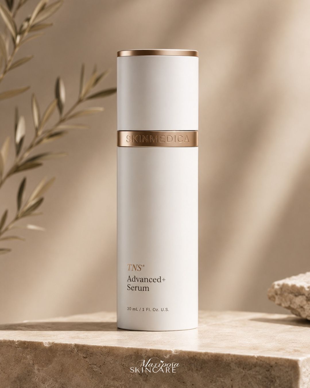SkinMedica TNS Advanced+ Serum in elegant white bottle with gold accents, set against soft natural backdrop